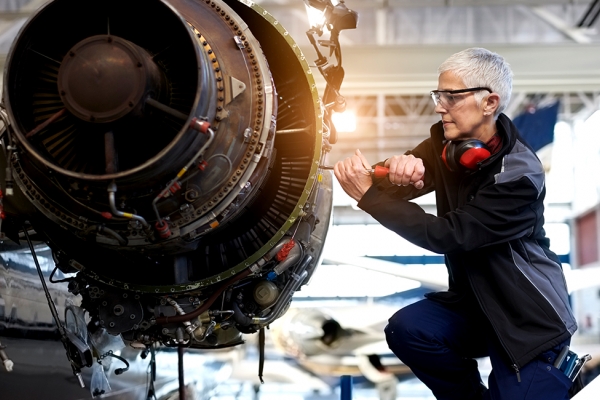 person working on aircraft turbine