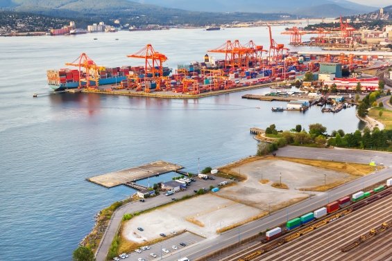 Grandes grues de chargement de fret chargeant des conteneurs sur des navires dans le port de Vancouver.