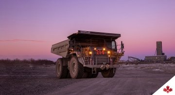 Large dumptruck in mine during sunset