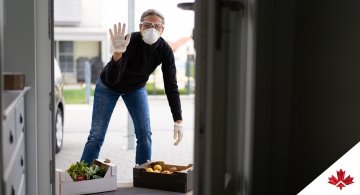 women wearing mask and delivering groceries