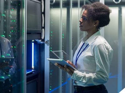 woman using tablet in server room